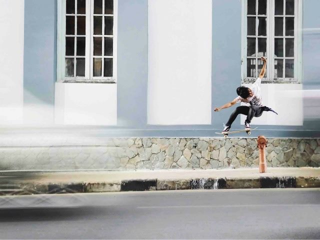 skateboarder ollie over a fire hydrant