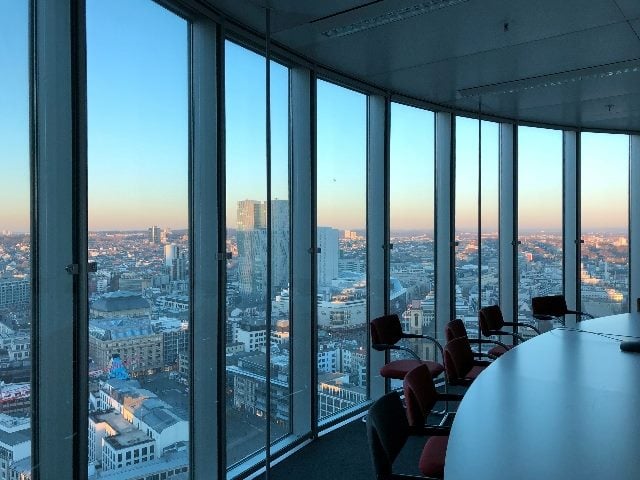 View from an executive conference room overlooking a city landscape.