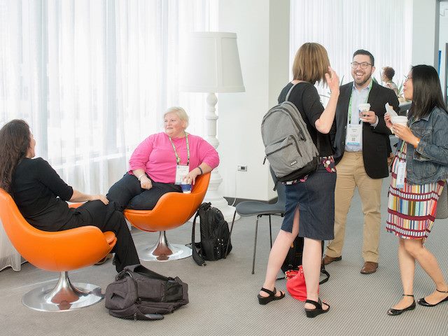 conference attendees networking in a hallway