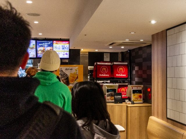  In Tokyo, customers line up at a fast food restaurant counter. 