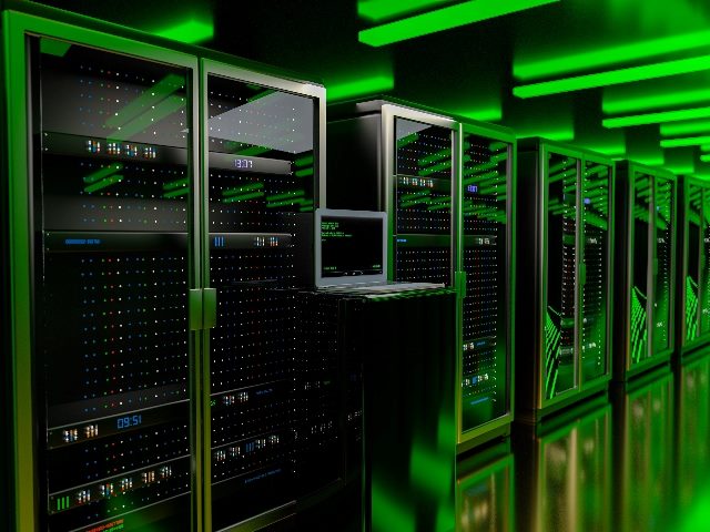 A server room with data storage units lit overhead with eerie bright green lighting in piece about the lack of data sustainability efforts. 