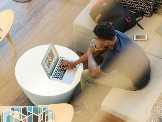 man looking at his laptop viewed from above