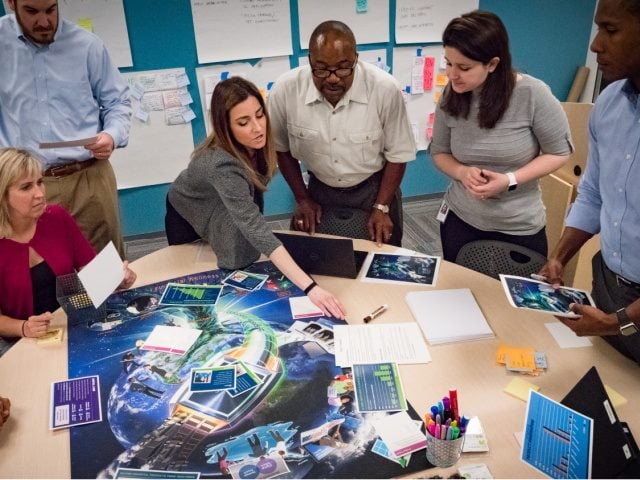 The Digital Labs team in the Information Services Department at Navy Federal Credit Union work together on a project.