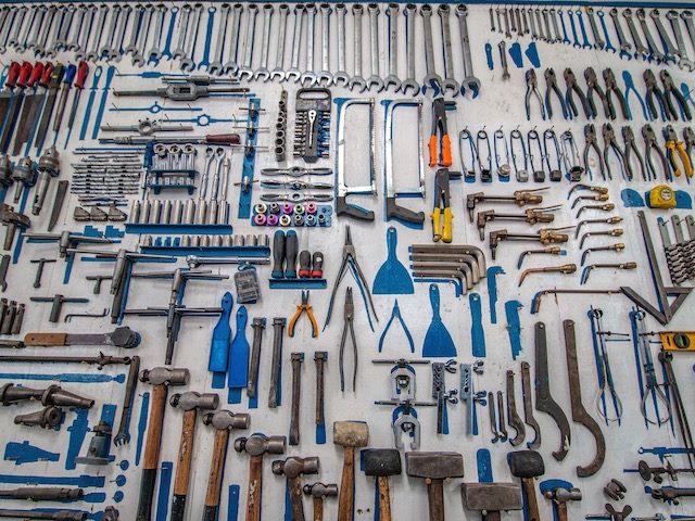 many many tools laid out  on the ground in geometric design