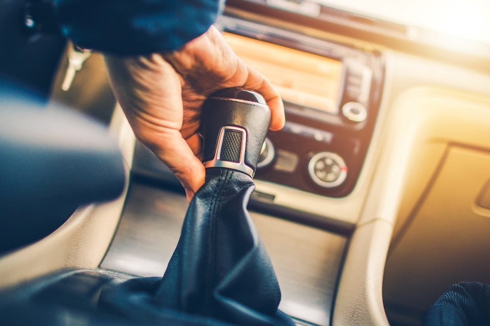 A person shifts gears on a standard gear shift in a car in a piece about demonstrating value for customers.