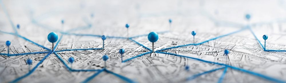 A roadmap with blue stick pins showing various destinations in a piece about roadmapping digital commerce strategy.