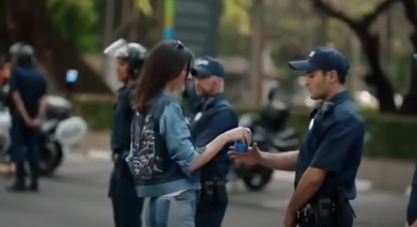 Kendall Jenner Pepsi ad where she hands a soda to a police officer during a protest