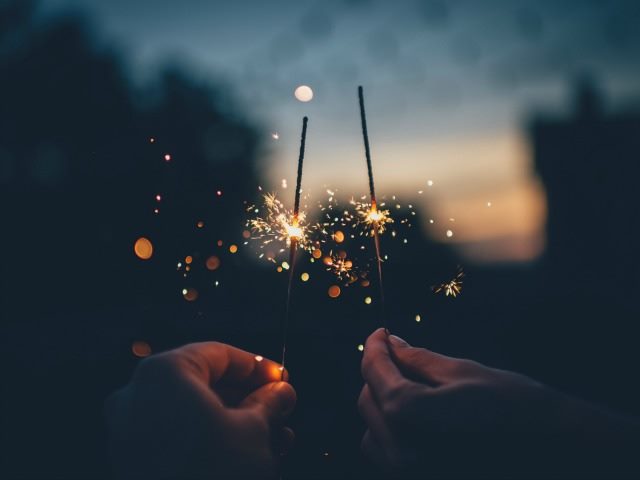 two people with sparklers