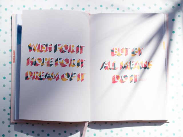 white book on a polka dot background with a text message saying do it