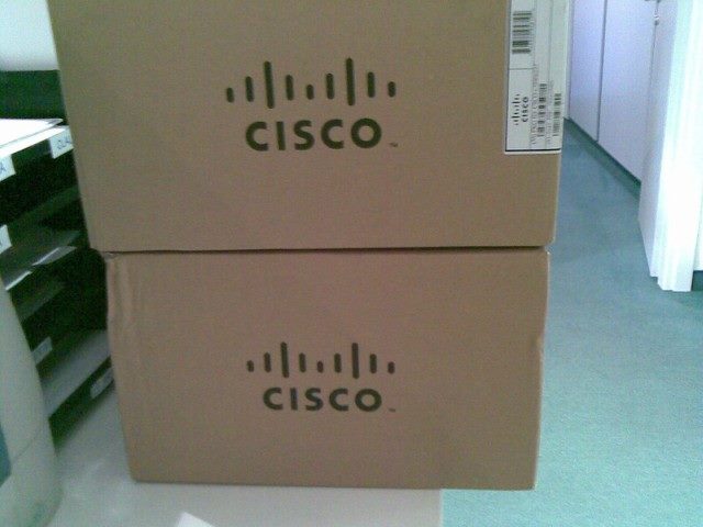 Two Cisco-branded boxes stacked upon one another.