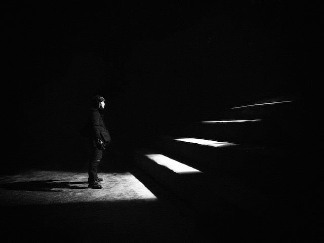 man facing set of stairs