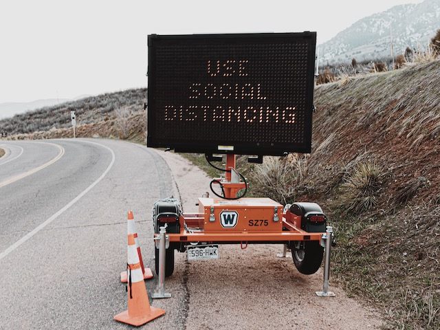 roadside sign  reading  "use  social distancing"