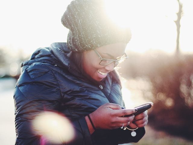 happy woman looking at her  cellphone