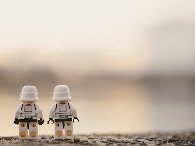 two lego stormtroopers with  their backs to  us