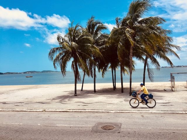 man riding a bicycle on the beach