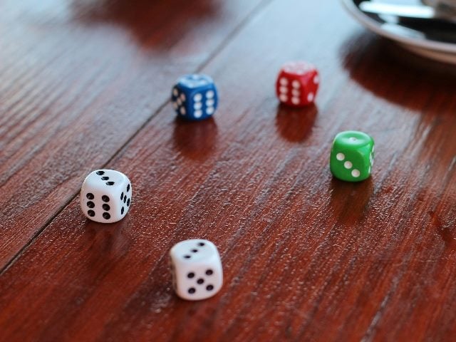 Multi-colored dice on a table.