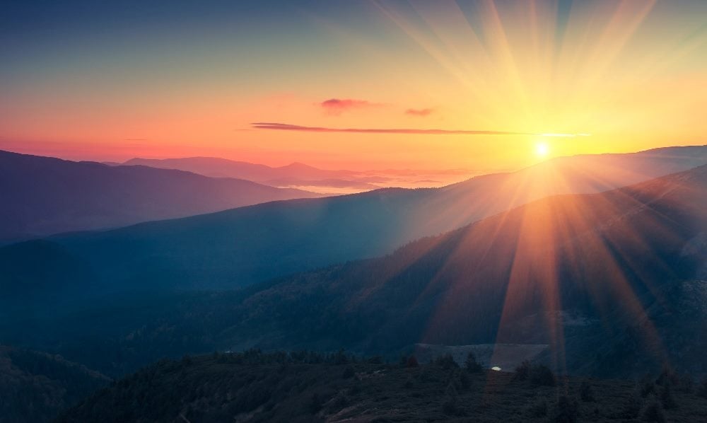 Panoramic view of colorful sunrise in mountains in piece about blended ecommerce strategies.