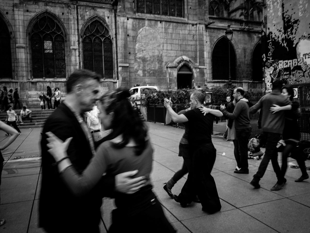 Several couples dancing in a black-and-white image.