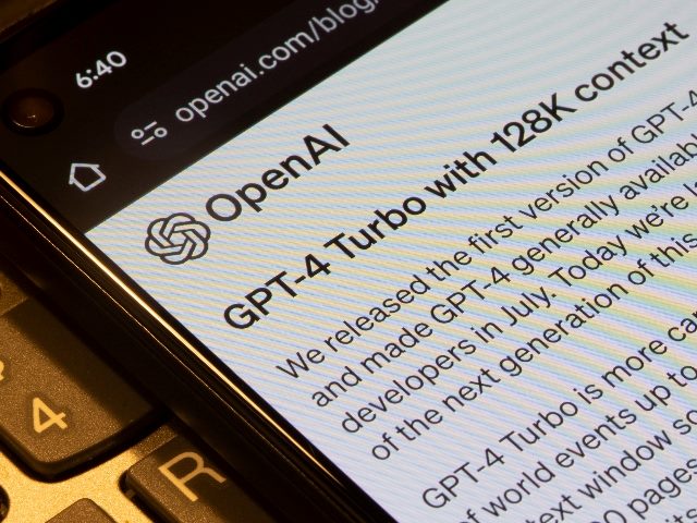 Webpage of GPT-4 Turbo is seen on OpenAI's corporate blog on a smartphone. OpenAI rehired Sam Altman as CEO. 