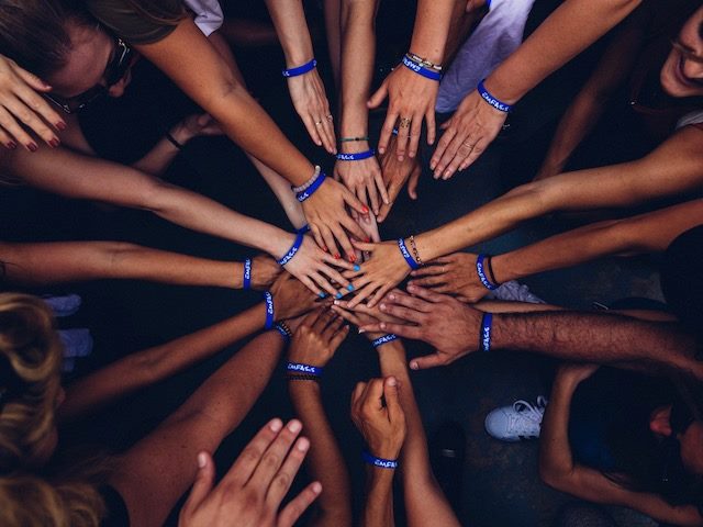 group of hands together (remember when we could  do that?)