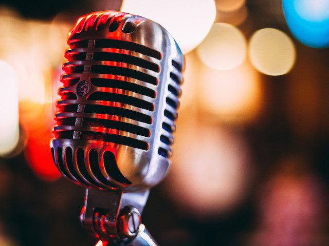 microphone in foreground with blurred lights in the background