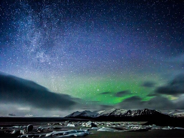 The northern lights over icebergs in Iceland. 