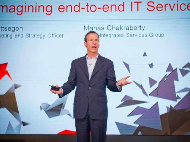 Paul Gottsegen on stage giving a talk at a recent technology conference.