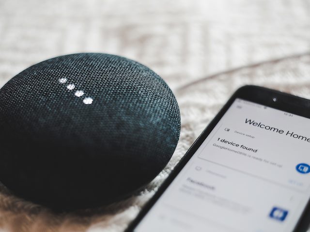 smart home device with smart phone next to it
