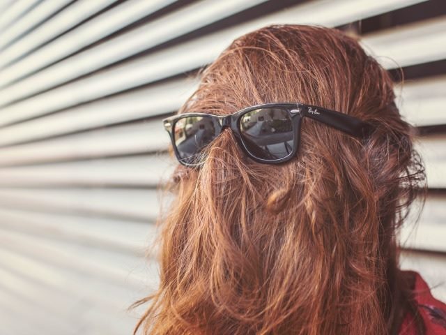 hair in front of the face with a pair of sunglasses