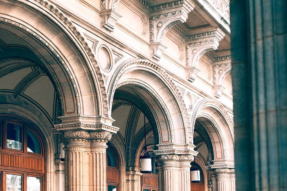 Architectural arches in Baroque Style, eetails of architectural arches and columns of the Vienna Opera Building in piece about building trust in organizations.