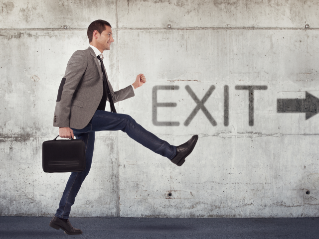 Young businessman leaving the building after resignation