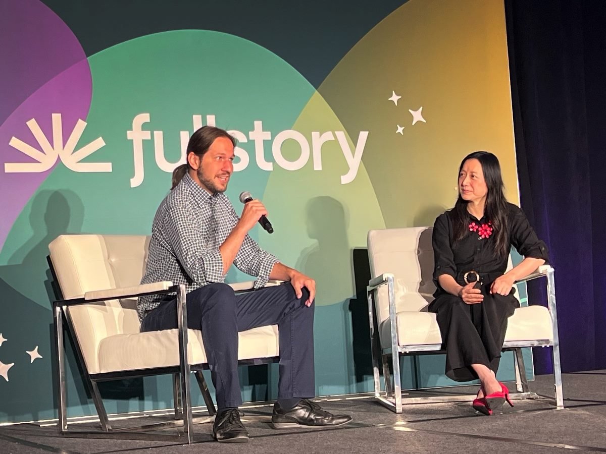 Usetiful CEO Ondrej Dobias and Fullstory Chief Product and Technology Officer Claire Fang speak on stage during a discussion at a Fullstory event.