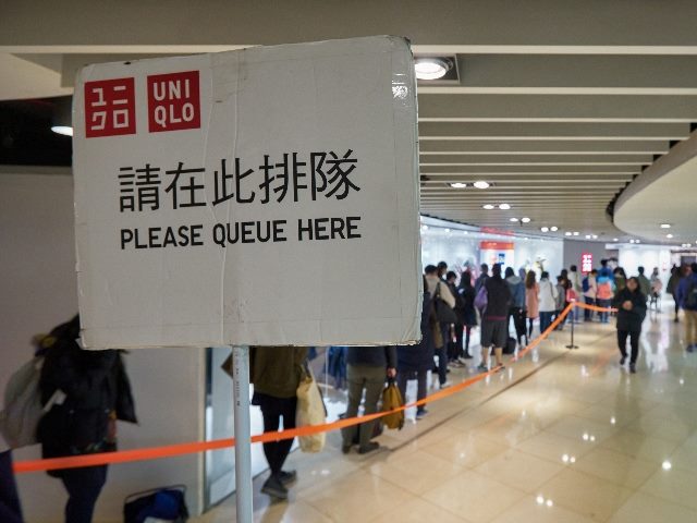 People waiting in line at Uniqlo store in New Town Plaza shopping mall in Hong Kong. 