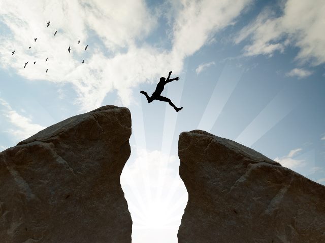 Man jumping over rocks.