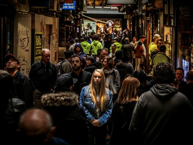 Woman in a denim jacket in a crowd