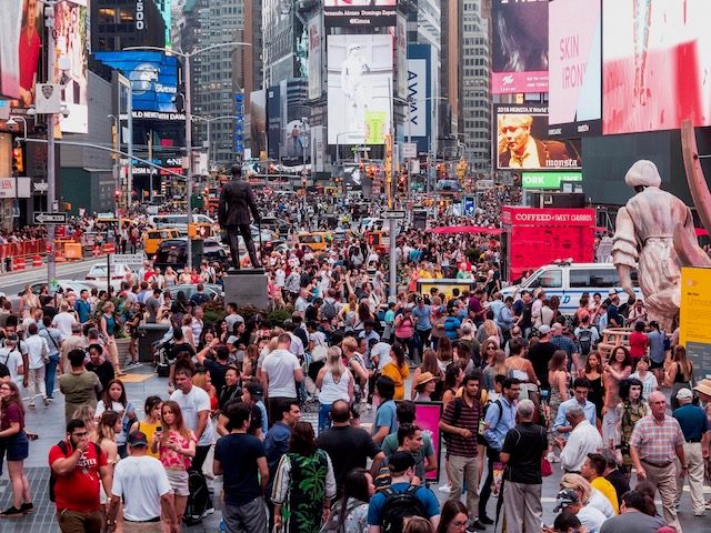 crowd in Times Square surrounded by billboards for different brands