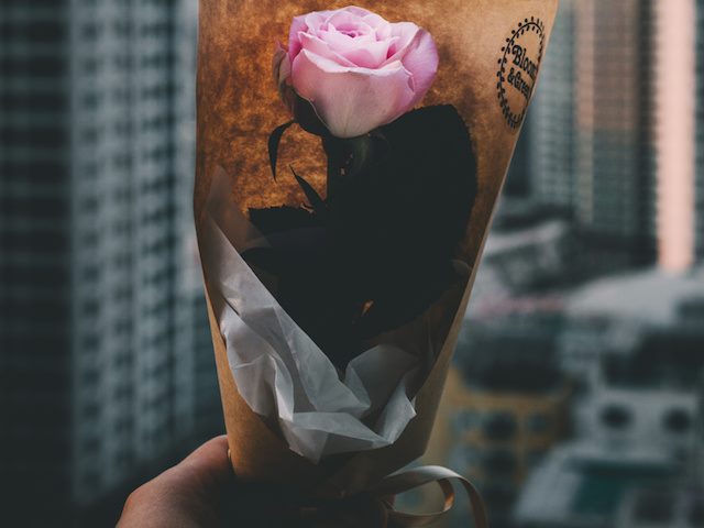 holding out a flower