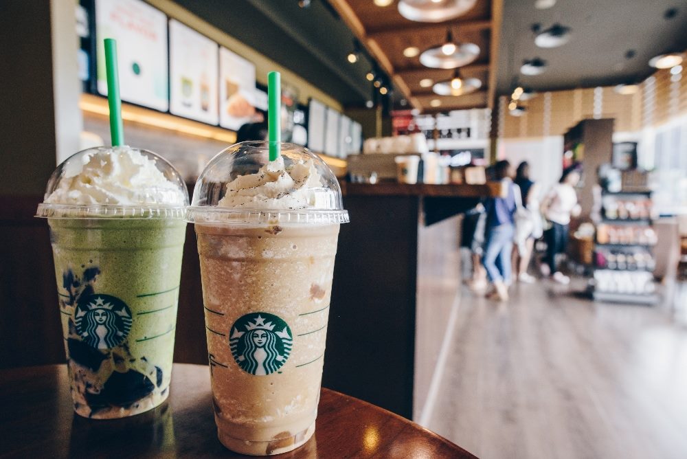 Starbucks frappuccino Irish coffee and Green tea latte frappuccino in Starbucks coffee shop in piece about customer experience strategies.
