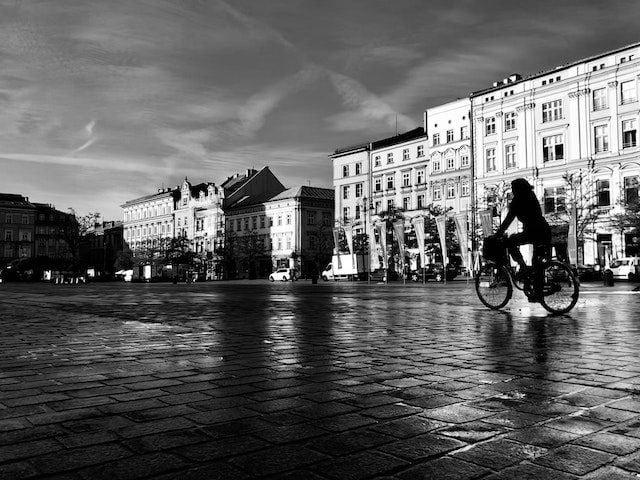 bicyclist riding through city square