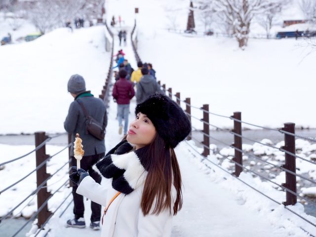 woman on a bridge in the snow