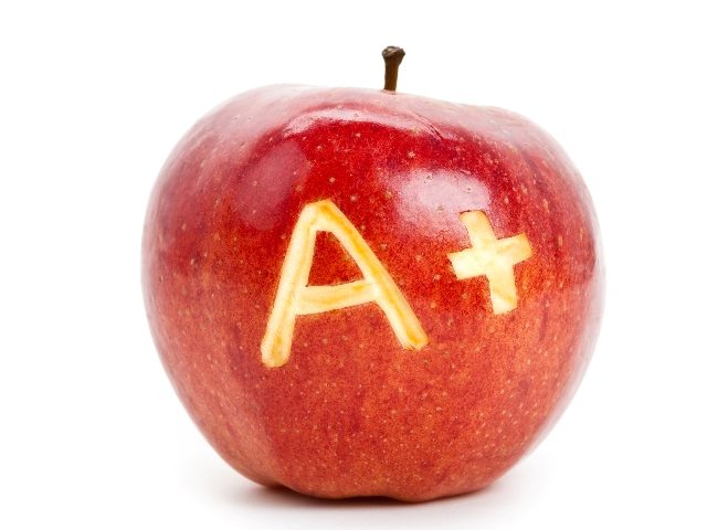 A red apple with an "A+" carved into it's peel sits on a white surface with a white background, suggesting shifting consumer behavior and need for customer trust. 
