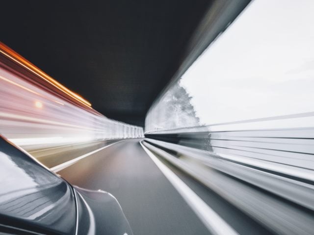time lapse photo of a car moving fast on a road