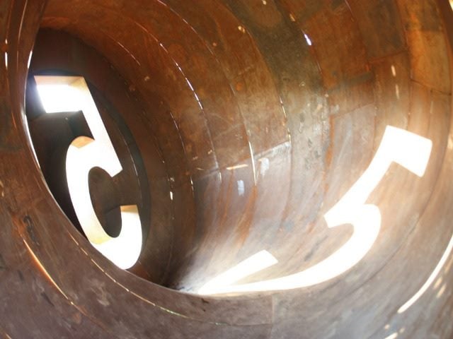 the number five reflected in a cylinder
