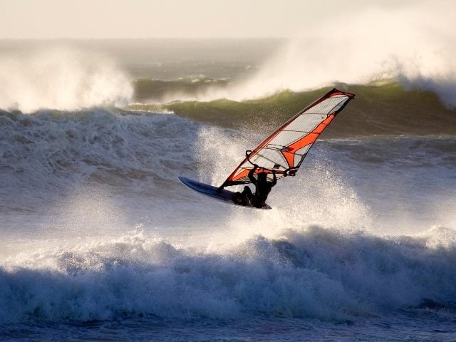 A wave-sailor taking on a powerful ocean, just like brands should take on some innovative new consumer trends.