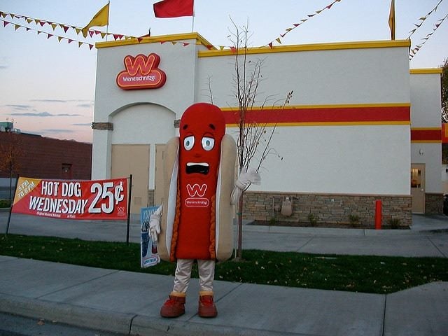 person dressed up in a hot dog costume promoting 25-cent hot dog wednesdays