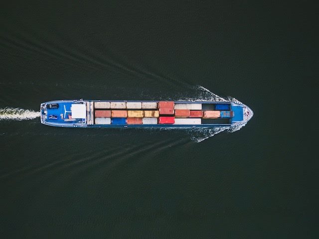 shipping containers on a barge in the river
