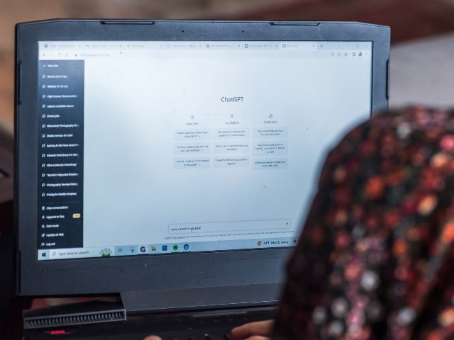 Woman on laptop using ChatGPT.