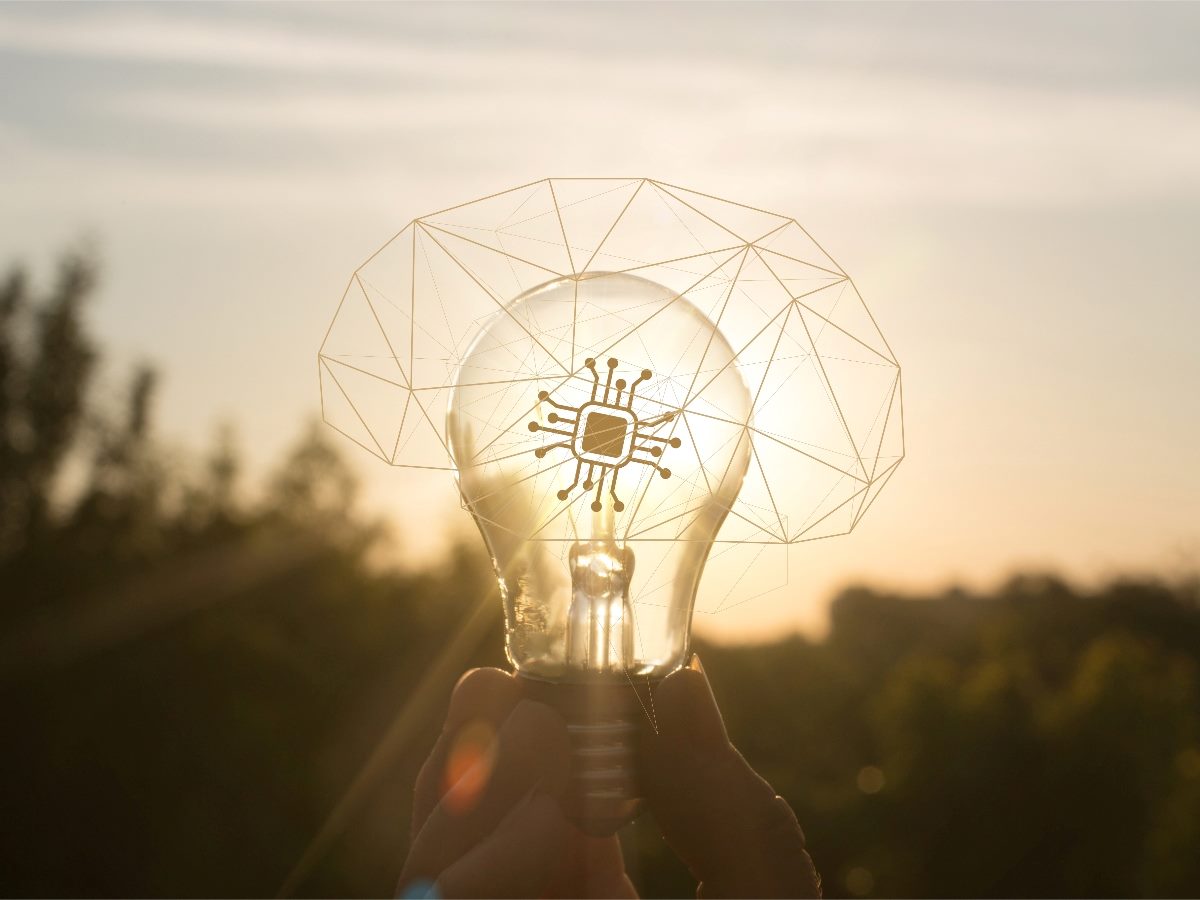 Light bulb transcendent, with sun in the background.