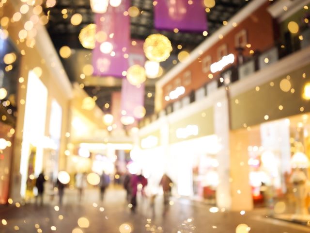  Shopping mall blurred background with holiday lights.