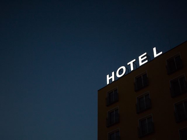 Hotel sign lit up in the night sky